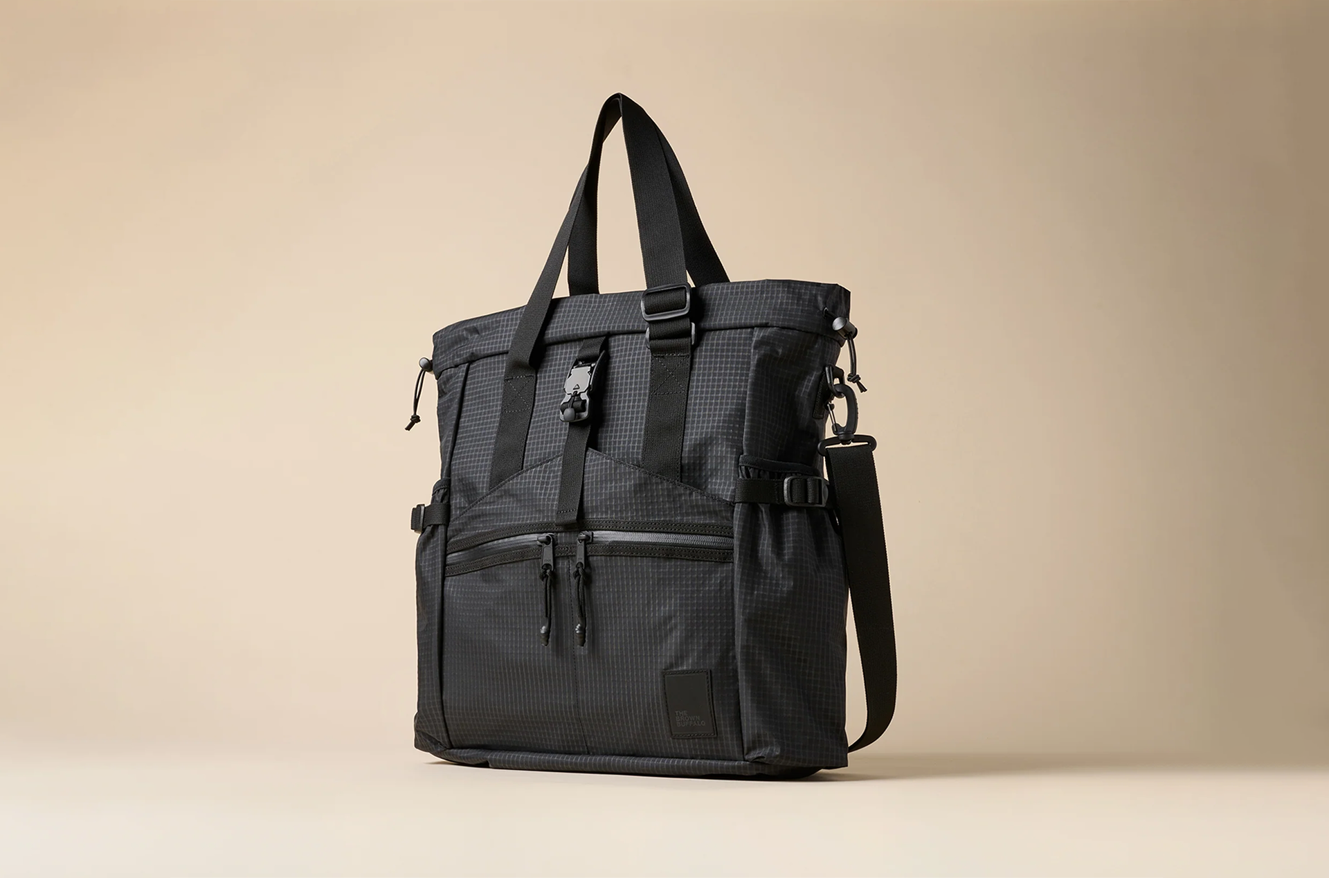 The Brown Buffalo Conceal Tote Black backpack on a beige background