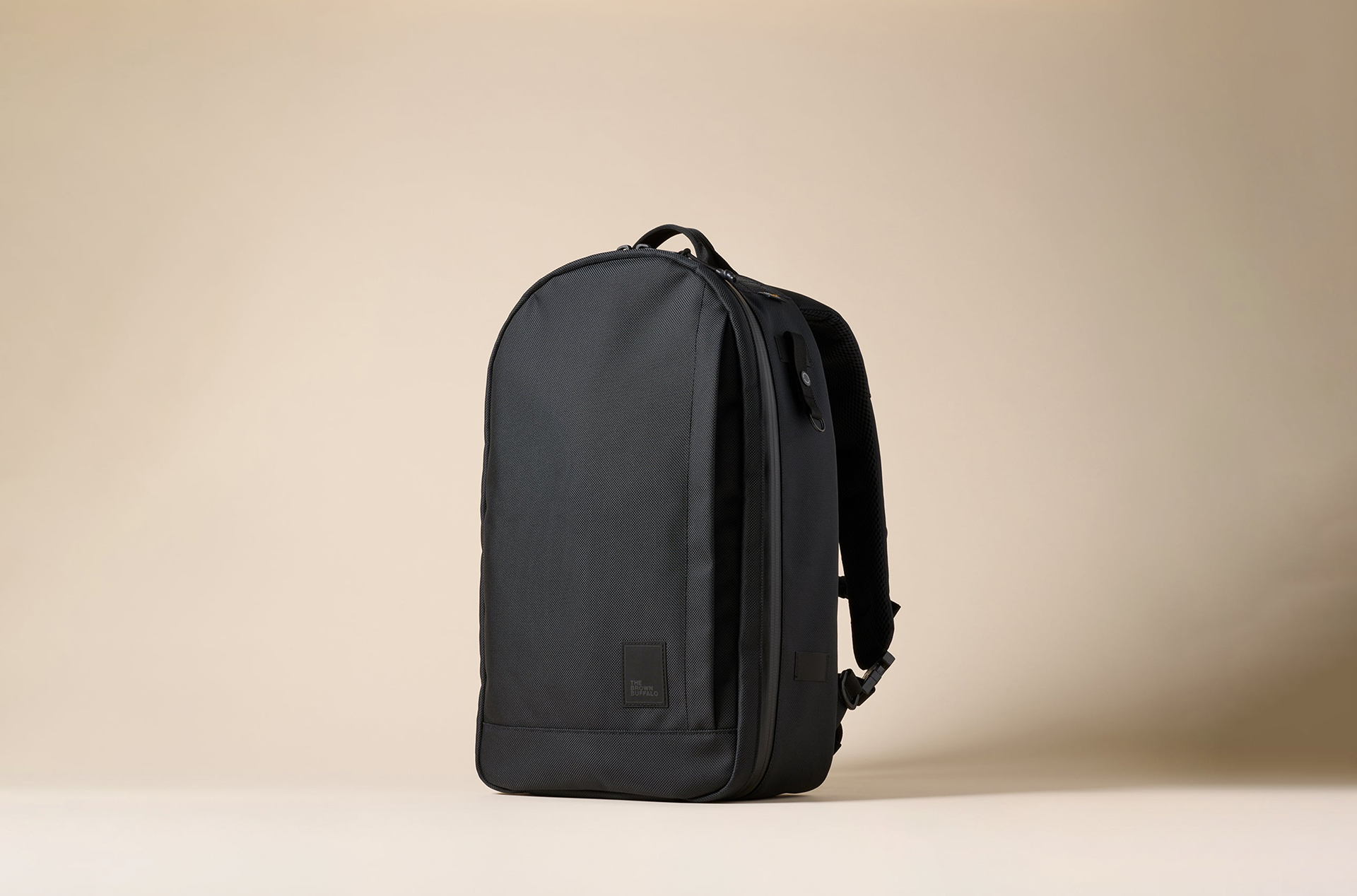 The Brown Buffalo Conceal Pack Black backpack on a beige background